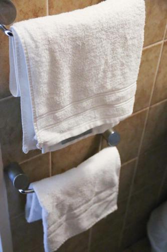 two white towels hanging on a rack in a bathroom at Hotel Berliner Hof in Düsseldorf