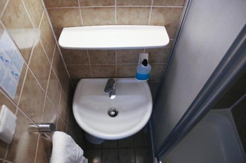 a small bathroom with a toilet and a sink at Hotel Berliner Hof in Düsseldorf