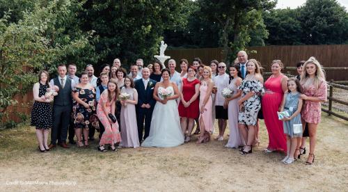 a group of people posing for a picture at a wedding at Twin Oaks Hotel in Chesterfield