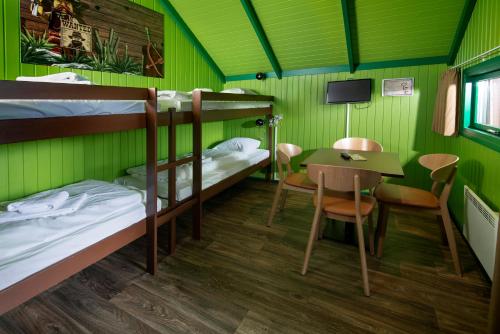 a room with two bunk beds and a table at LEGOLAND Wilderness Barrels & Cabins in Billund