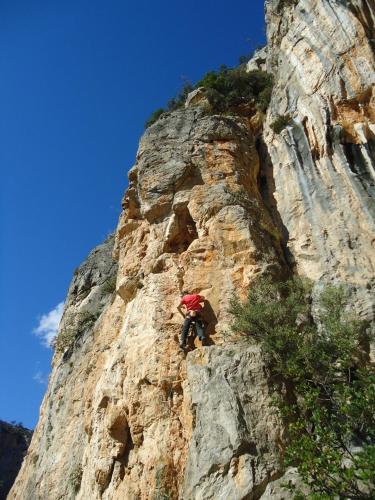 a person climbing on the side of a mountain at Leonidio Climb2red home in Leonidion