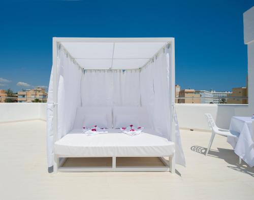 a white canopy bed on a balcony with a view at My Way Luxury Ibiza Studio - AB Group in Playa d'en Bossa