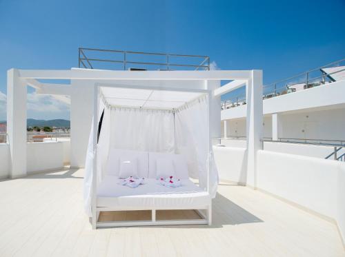 a white swing on the roof of a house at My Way Luxury Ibiza Studio - AB Group in Playa d'en Bossa