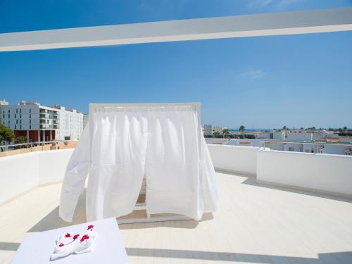 a pair of white shoes sitting on a roof at My Way Luxury Ibiza Studio - AB Group in Playa d'en Bossa