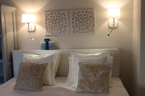 a bedroom with two pillows on a bed with two lights at Akti Elia Villas Beachfront Chalkidiki in Elia