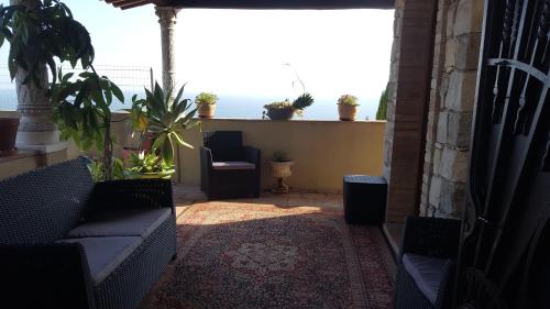 a balcony with couches and a view of the ocean at Villa Azur Cap d'Ail in Cap d'Ail