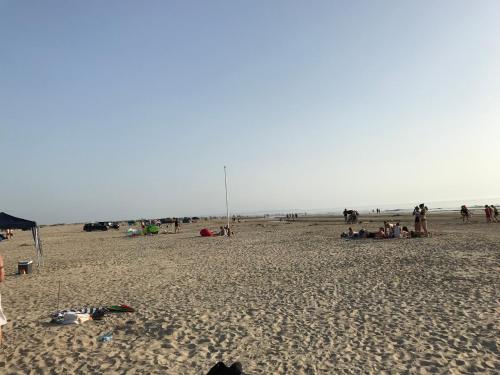 a group of people sitting on a beach at Gulirisvej Havneby Rømø in Rømø Kirkeby