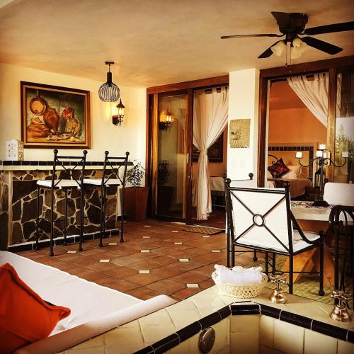 a living room with a couch and a fireplace at Casa Miura Hotel Boutique in Ajijic