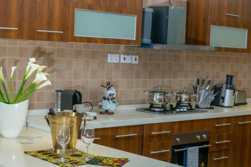 a kitchen with a counter top with a stove top oven at Enkombe Place in Kampala