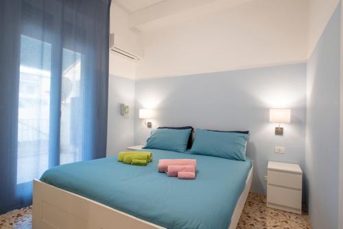a bedroom with a bed with two pillows on it at DELPOSTO Marina di Ragusa (lp) in Marina di Ragusa