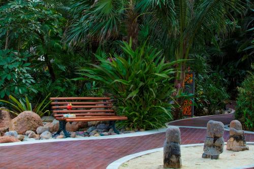 a bench in a garden with rocks and plants at Krystal Grand Nuevo Vallarta in Nuevo Vallarta 