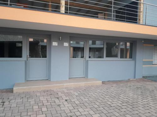 a building with three doors on the side of it at Apartments Akacijev Izvir in Miklavž na Dravskem Polju