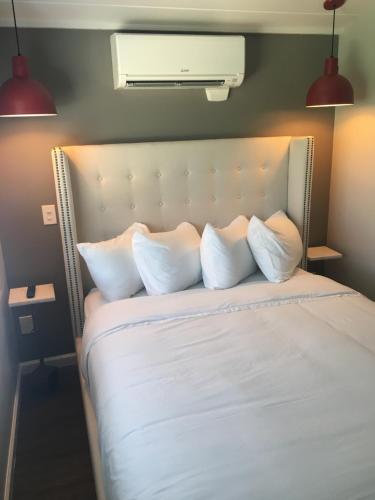 a bedroom with a bed with white sheets and pillows at Flying Flags RV Resort & Campground in Buellton