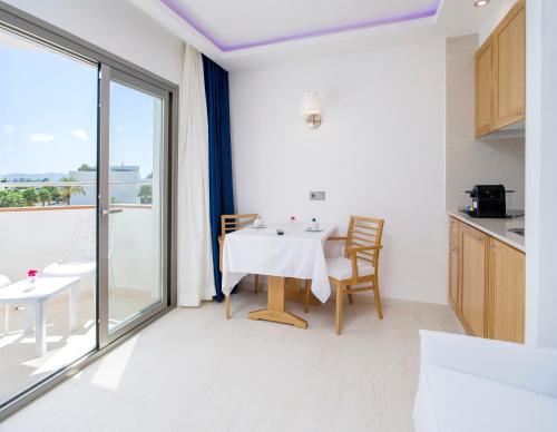 a kitchen and dining room with a table and a window at My Way Luxury Ibiza Studio - AB Group in Playa d'en Bossa