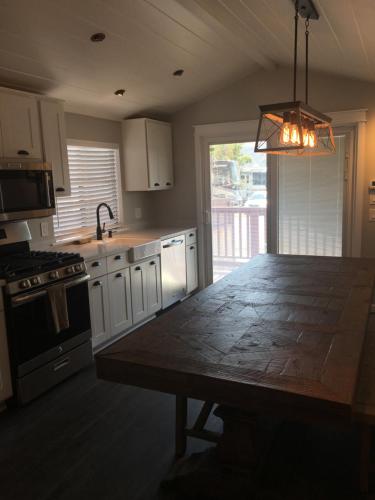 a kitchen with a table and a stove and a sink at Flying Flags RV Resort & Campground in Buellton