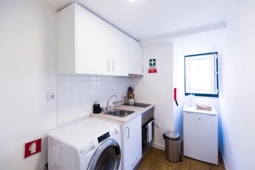 een keuken met een wasmachine en een wastafel bij Olá Lisbon - Bairro Alto II in Lissabon