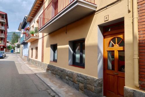 a building with a wooden door on the side of a street at Sweet Dreams in Campdevánol