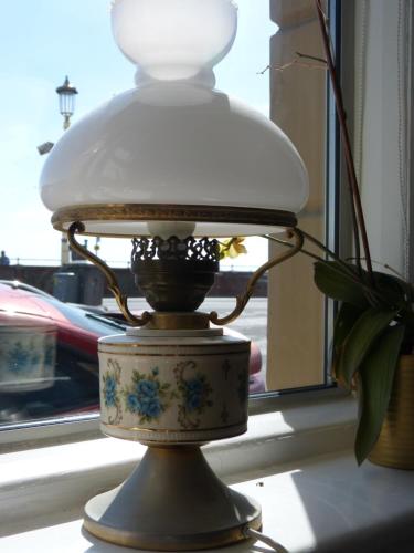 a lamp sitting on a table in a window at The Iverna in Eastbourne