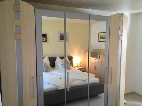 a bedroom with a mirrored closet and a bed at Ferienwohnung Karin in Bludenz