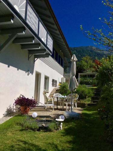 a patio with an umbrella and a table and chairs at Ferienwohnung Karin in Bludenz