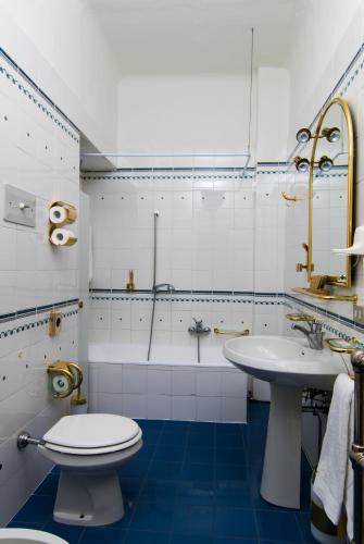 a bathroom with a toilet and a sink and a shower at Residence Grand Hotel Carezza in Nova Levante