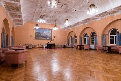 a large room with a grand piano in it at Residence Grand Hotel Carezza in Nova Levante