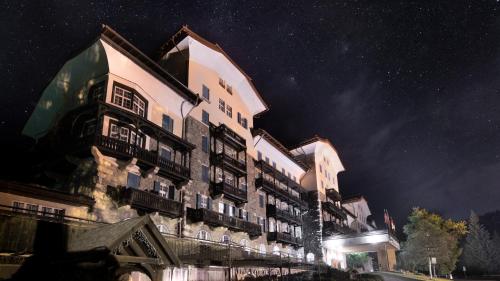a large building at night with a starry sky at Residence Grand Hotel Carezza in Nova Levante