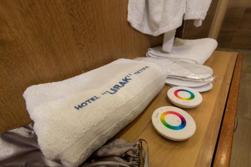 a wooden table with a towel with the words new york times at Hotel Lirak in Tetovo