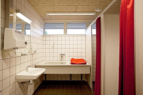 a bathroom with a sink and a bath tub at LEGOLAND Wilderness Barrels & Cabins in Billund