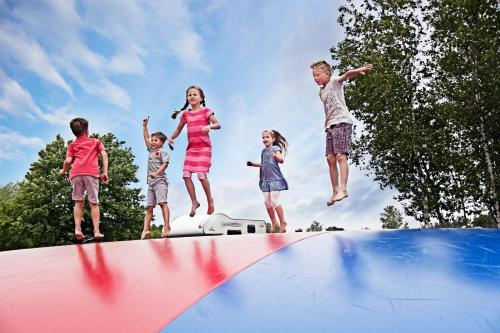 a group of children jumping on a trampoline at LEGOLAND Wilderness Barrels & Cabins in Billund
