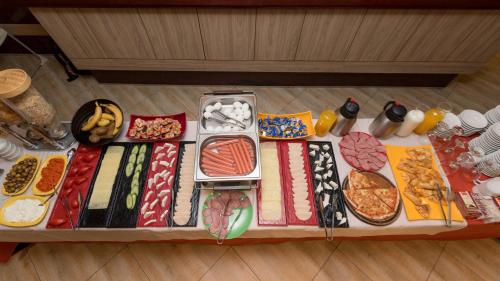 a table filled with different types of food at Hotel Lirak in Tetovo