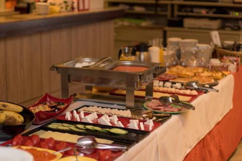 a buffet line with many different types of food at Hotel Lirak in Tetovo