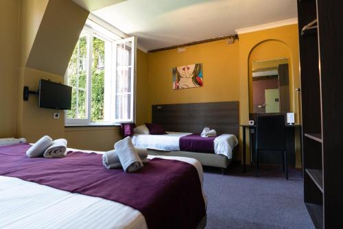 En eller flere senge i et værelse på Flandria Hotel