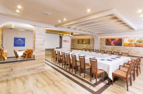 a conference room with a long table and chairs at Hotel Lirak in Tetovo