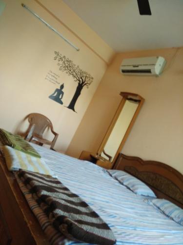 a bedroom with a bed with a blue comforter at Gerones Residency Serviced Apartments & Home Stays in Coimbatore