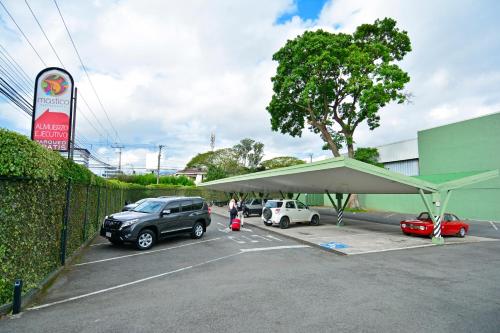 a parking lot with cars parked under a tent at Auténtico Hotel in San José