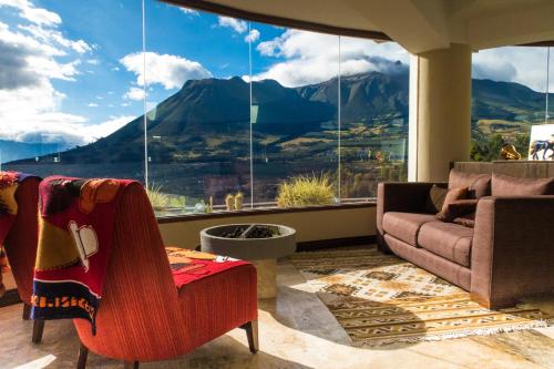 a living room with a view of a mountain at Hotel Medina Del Lago in Otavalo