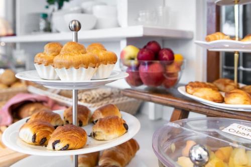 a display of pastries and breads on plates in a bakery at Weinstadt Hotel - das Original in Weinstadt