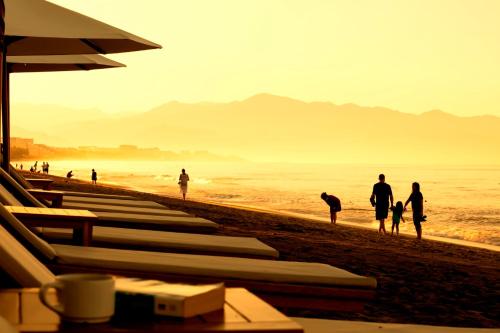 a group of people walking on the beach at Krystal Grand Nuevo Vallarta in Nuevo Vallarta 