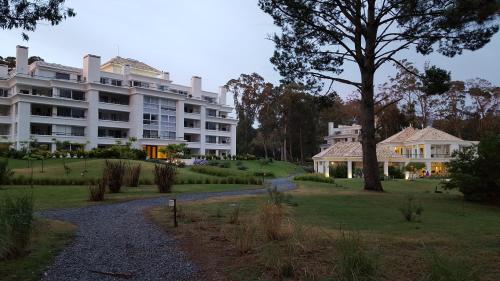 a large white building with a tree in front of it at Green Park in Punta del Este