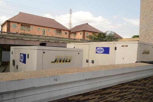 a group of buildings with jmg signs on them at Nue-Crest Hotels & Suites in Enugu