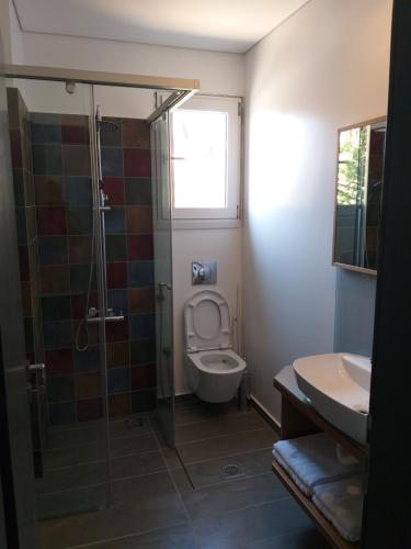 a bathroom with a toilet and a shower and a sink at Rustemi in Sarandë