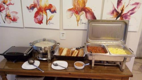 a table with a buffet of food on it at Vital Hotel in Marechal Floriano