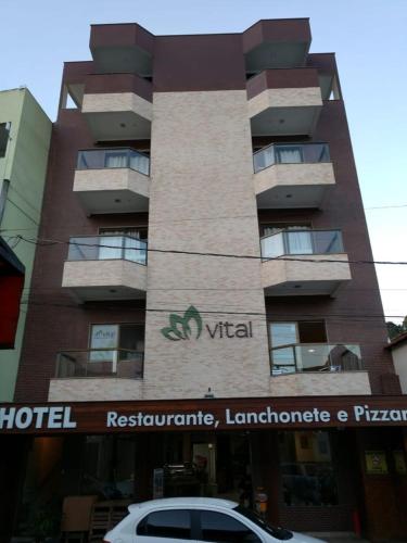 a hotel with a car parked in front of it at Vital Hotel in Marechal Floriano