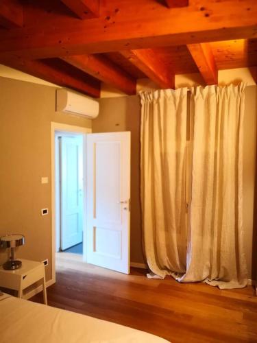 a bedroom with a bed and a door with a window at Villa Zen 2 in Padova