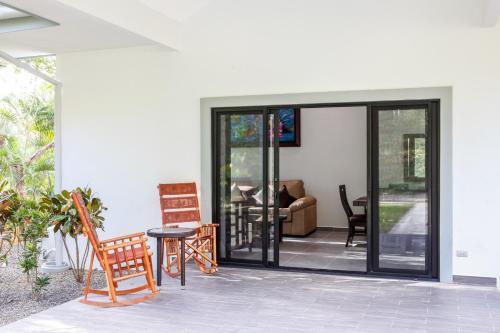 a living room with sliding glass doors at Hidden Palms in Nosara