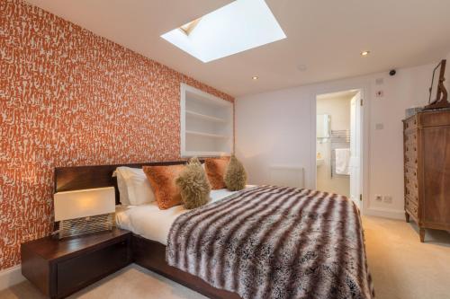 a bedroom with a large bed and a skylight at Altskeith Country House in Aberfoyle