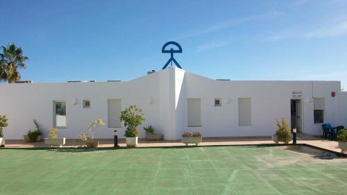 a white building with a cross on top of it at Virgen del Mar Holidays in Mojácar
