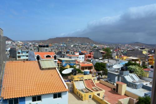 a city with buildings and a mountain in the background at Sol Hotel in Praia