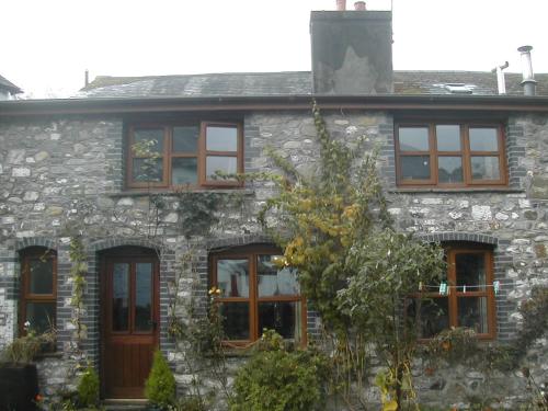 a stone house with a bunch of windows at Neuadd Arms Hotel in Llanwrtyd Wells